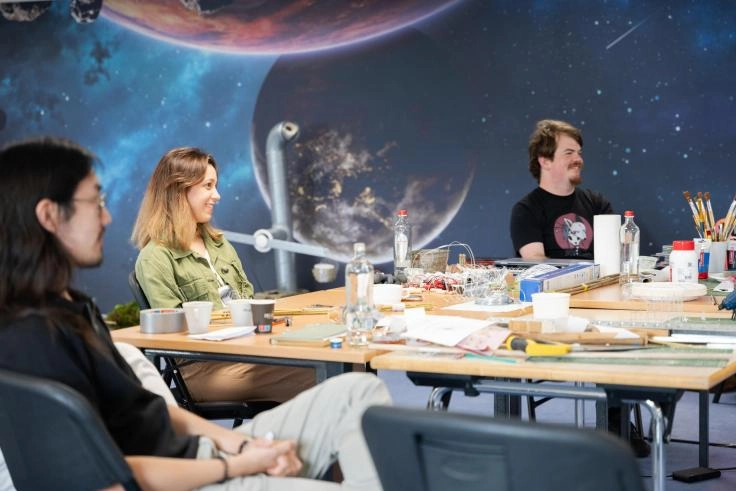 People participating in the SciArts workshop around a table